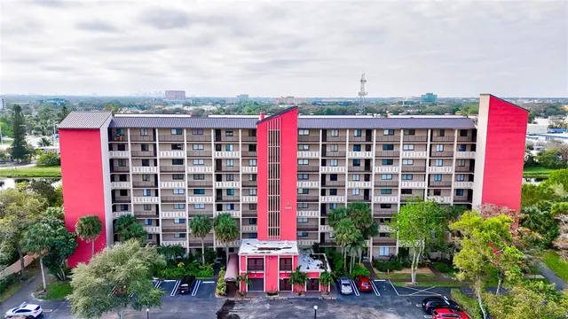 a front view of multi story residential apartment building with yard