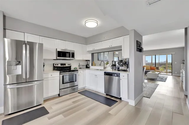 a kitchen with a refrigerator cabinets and stainless steel appliances