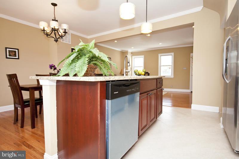 811 Wicklow Road Baltimore, MD 21229 - Photo 11 of 30 a kitchen with kitchen island granite countertop a sink and refrigerator