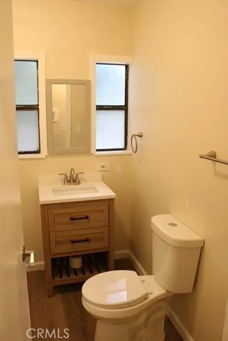 a bathroom with a toilet a sink and mirror