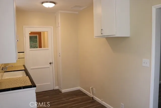 a room with wooden floor and cabinets