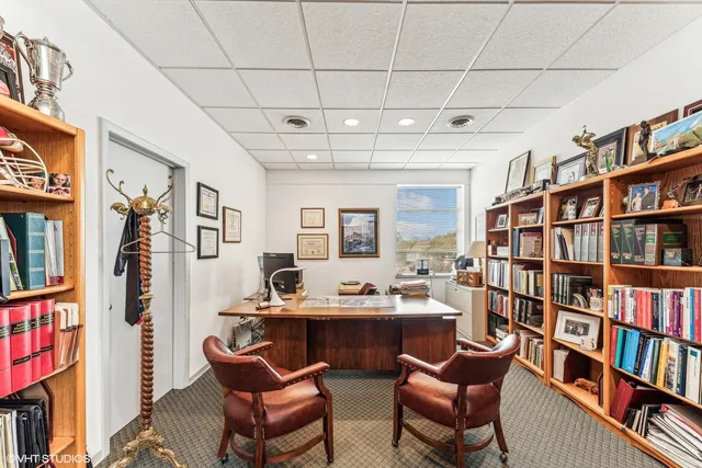 a living room with a book shelf and a book shelf