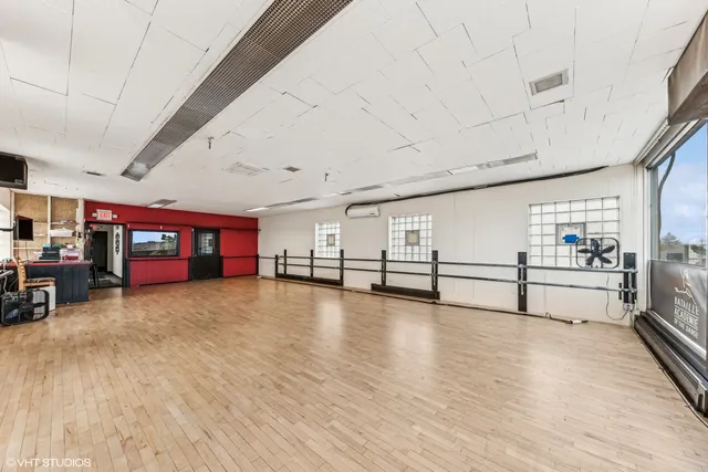 a view of a livingroom with hardwood and furniture