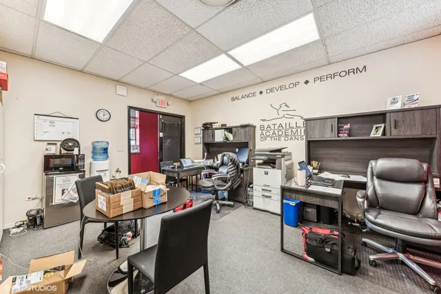 a work room with furniture and a large window