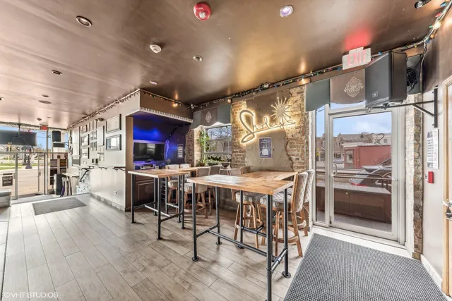 a kitchen with stainless steel appliances kitchen island granite countertop a table and chairs in it