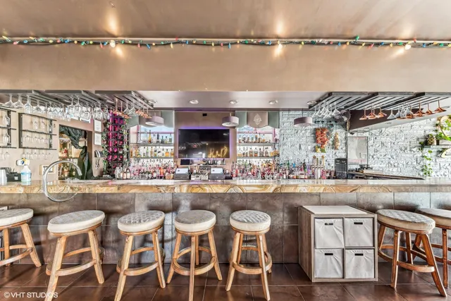 a kitchen with cabinets and chairs