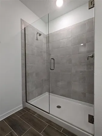 a bathroom with a glass shower door