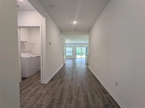 a view of hallway with wooden floor