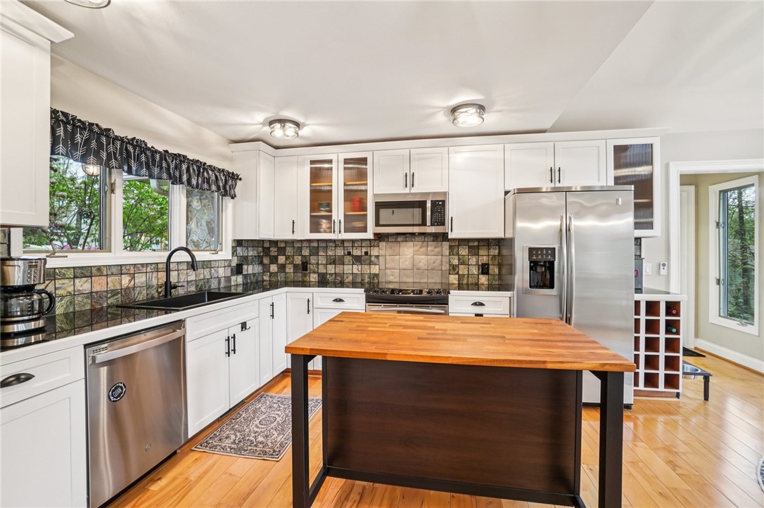 120 Beacon Ridge Circle Salem, SC 29676 - Photo 13 of 48 This bright kitchen features wood flooring and stainless steel appliances, creating a welcoming and functional space.