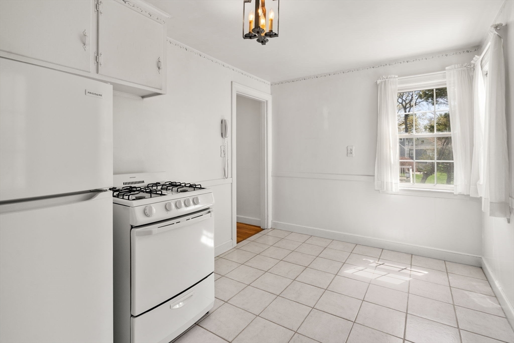 62 Felch Road Natick, MA 01760 - Photo 5 of 27 a kitchen with white cabinets and white appliances