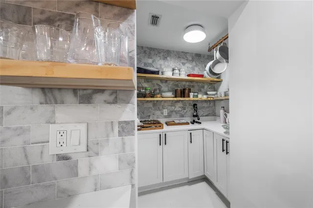 a kitchen with stainless steel appliances granite countertop a sink and cabinets