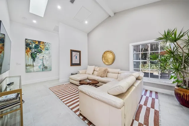 a living room with furniture and a potted plant