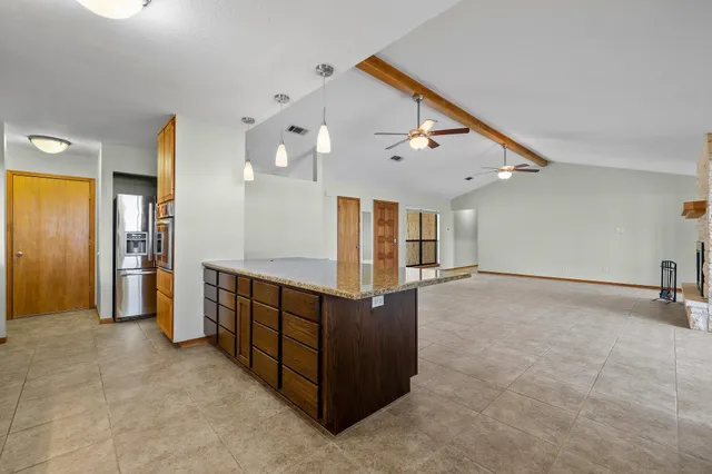 an empty room with windows and cabinet