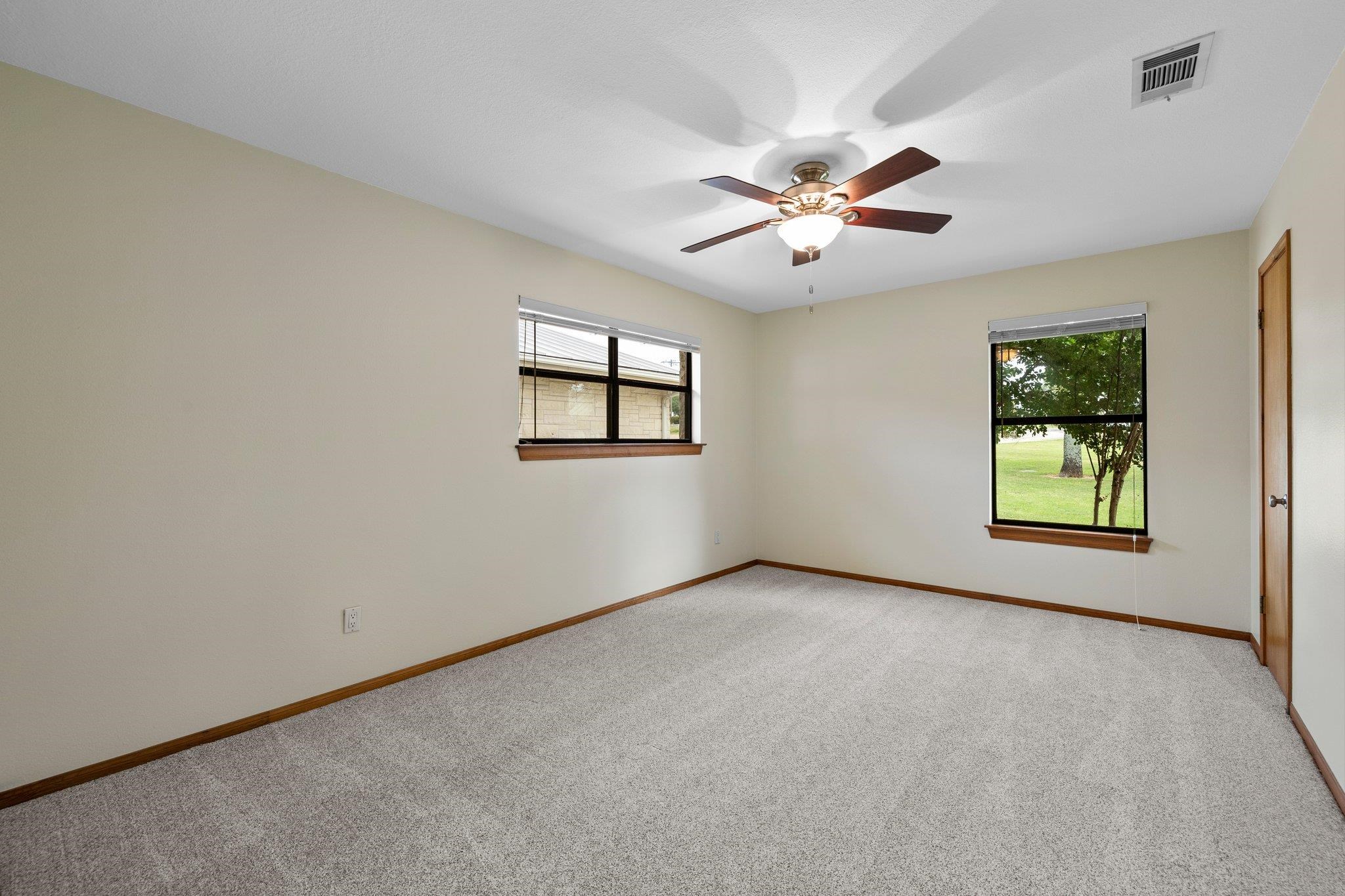 209 Senisa Drive Buchanan Dam, TX 78609 - Photo 14 of 30 an empty room with windows and ceiling fan