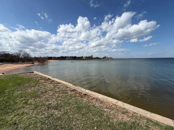 a view of a porch with wooden floor and fence