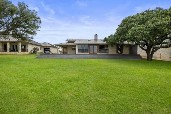 a view of house with a yard