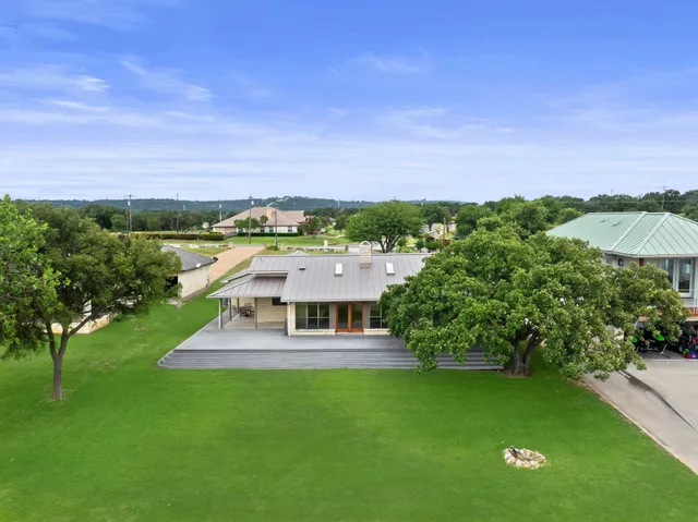 a view of house with a yard