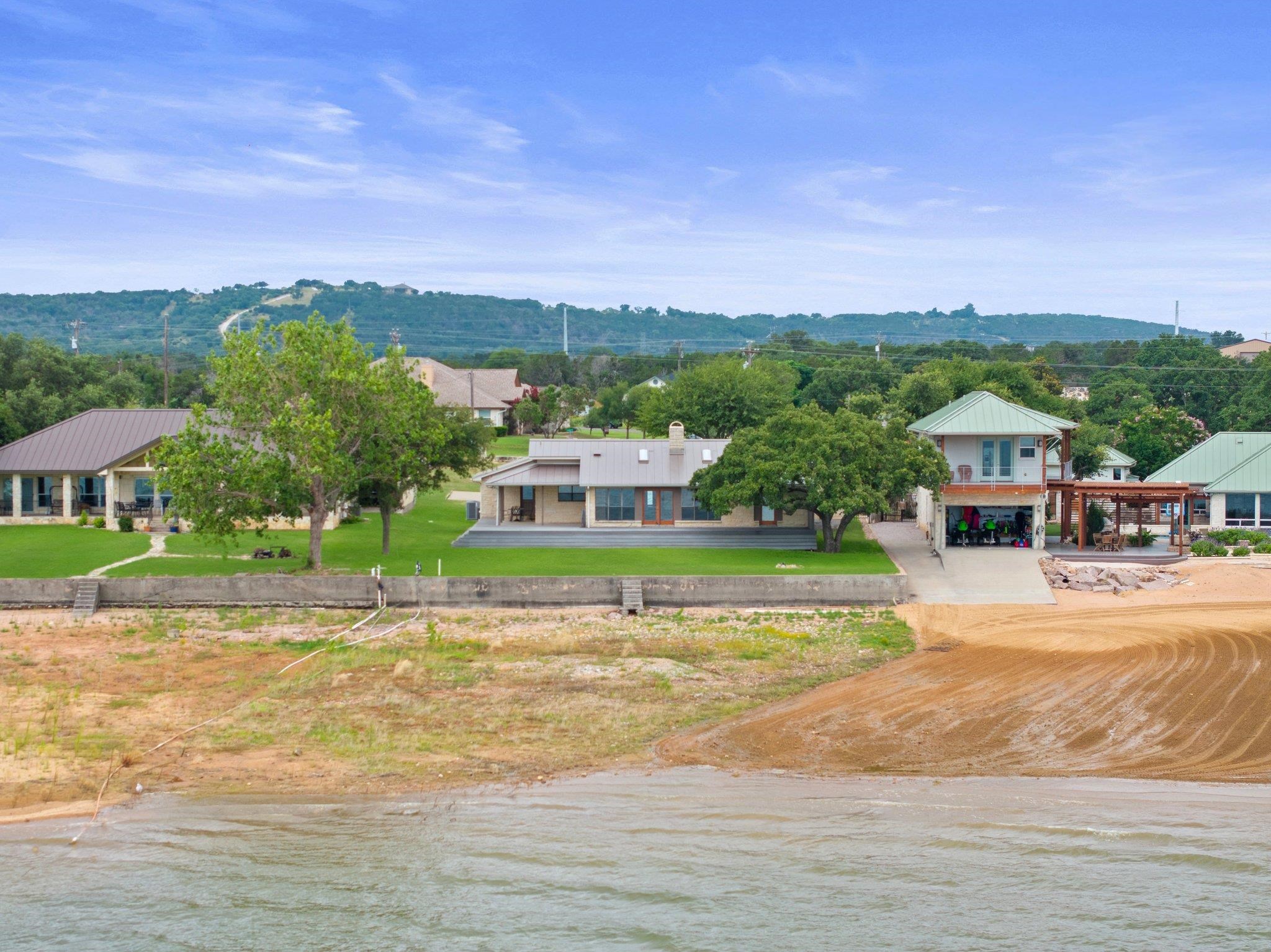 209 Senisa Drive Buchanan Dam, TX 78609 - Photo 26 of 30 a view of a big house with a big yard and palm trees