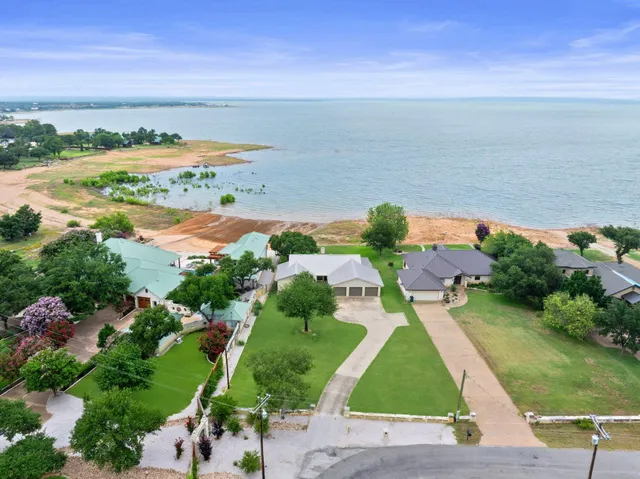 an aerial view of ocean with residential house with outdoor space