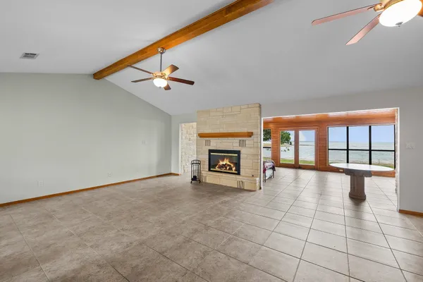 a view of a livingroom with fireplace and window