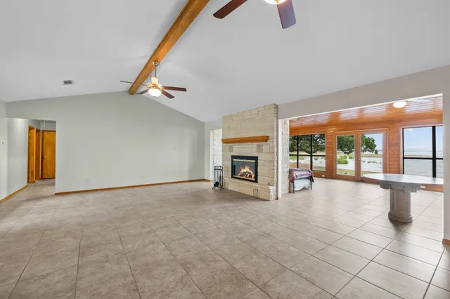 a view of an empty room with a fireplace