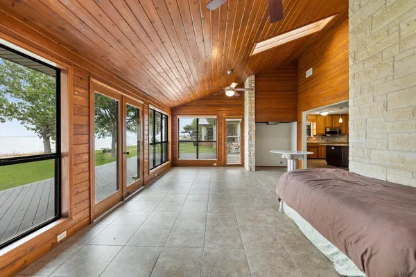 a large kitchen with granite countertop a large counter top cabinets and stainless steel appliances