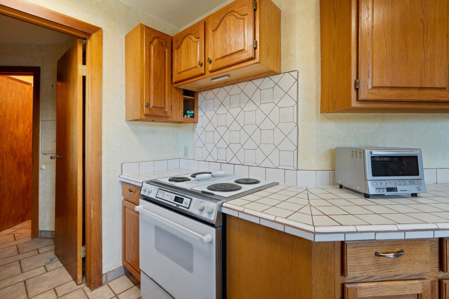 20101 Panoche Road Paicines, CA 95043 - Photo 22 of 97 a kitchen with stainless steel appliances granite countertop a stove a sink and a microwave