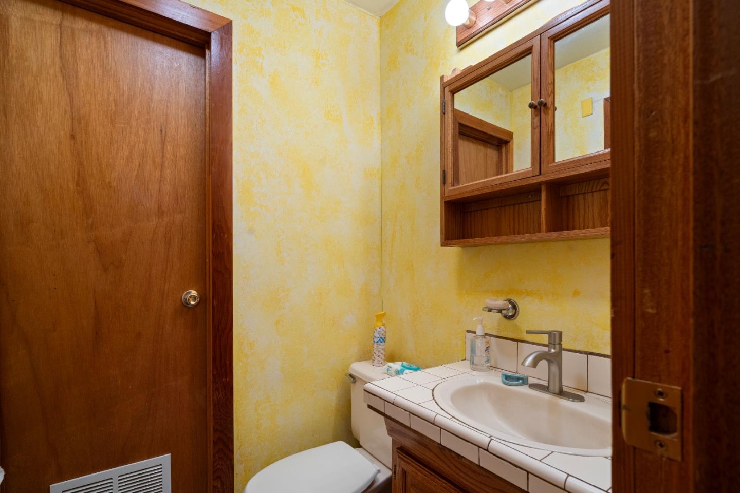 20101 Panoche Road Paicines, CA 95043 - Photo 25 of 97 a bathroom with a sink a toilet and mirror