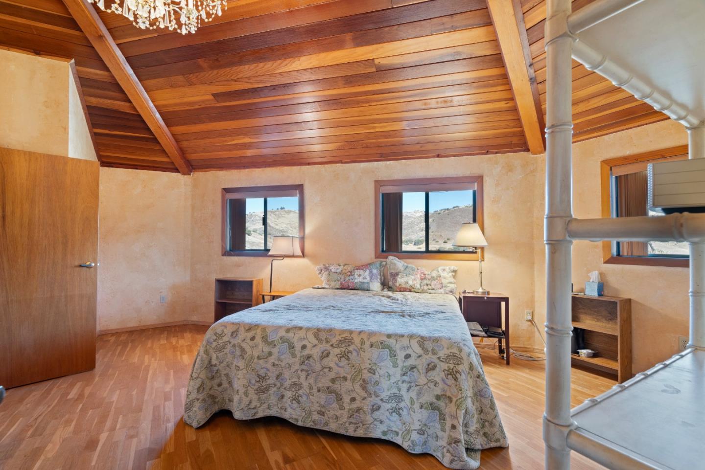 20101 Panoche Road Paicines, CA 95043 - Photo 33 of 97 a bedroom with a bed and wooden floor