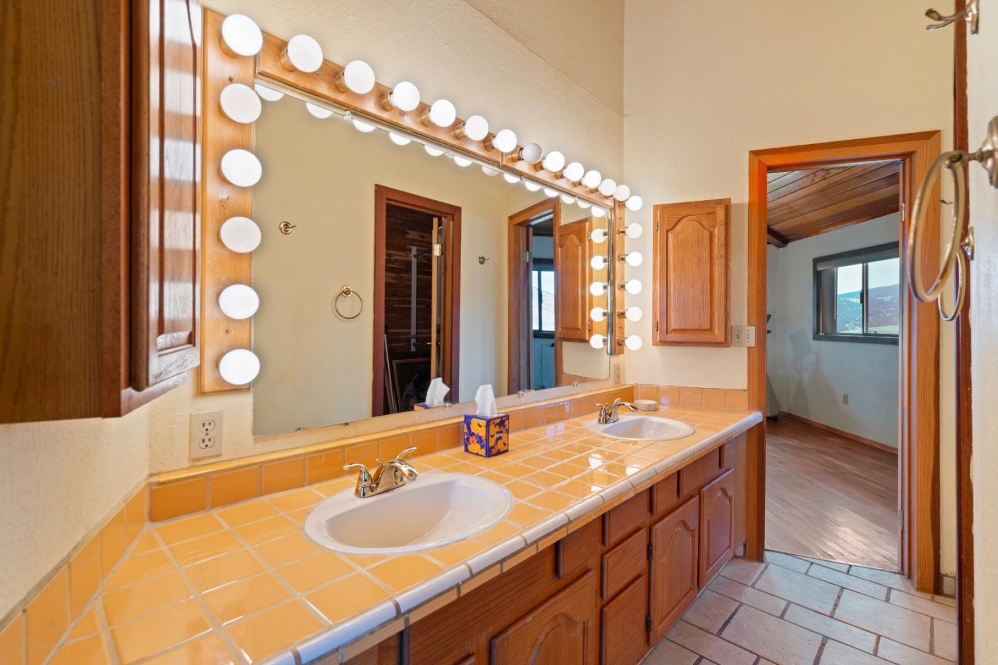20101 Panoche Road Paicines, CA 95043 - Photo 38 of 97 a bathroom with a granite countertop sink and a mirror