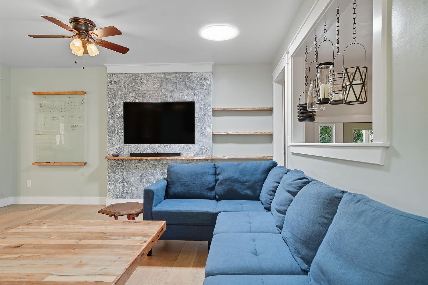 2988 Spring Hill Road San Andreas, CA 95249 - Photo 13 of 95 a living room with furniture a ceiling fan and a fireplace