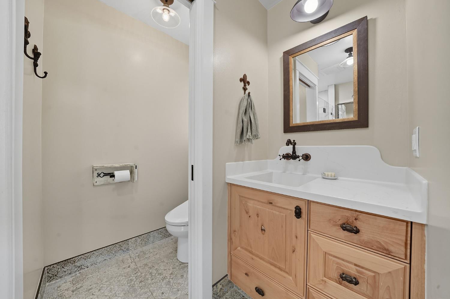 2988 Spring Hill Road San Andreas, CA 95249 - Photo 43 of 95 a bathroom with a sink a toilet and a mirror