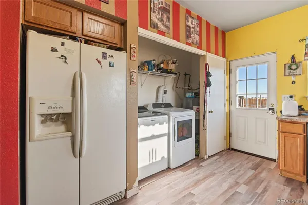 a kitchen with a refrigerator and white cabinets