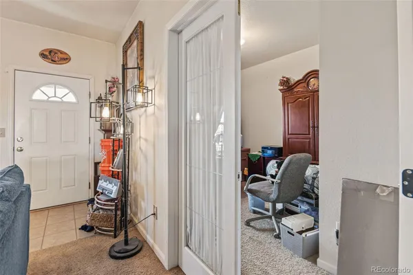 a view of a hallway with workspace and a window