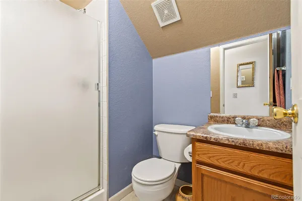 a white toilet sitting next to a bathroom sink