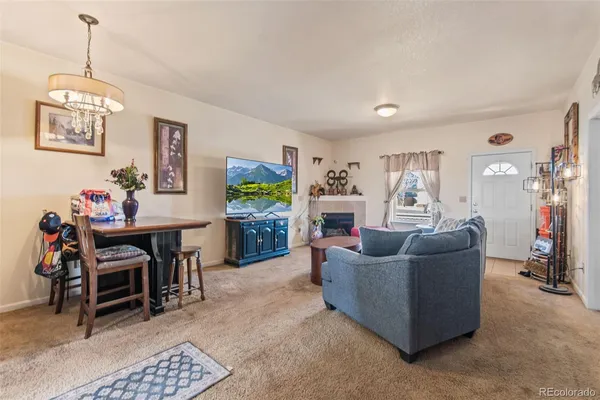 a living room with furniture and a dining room