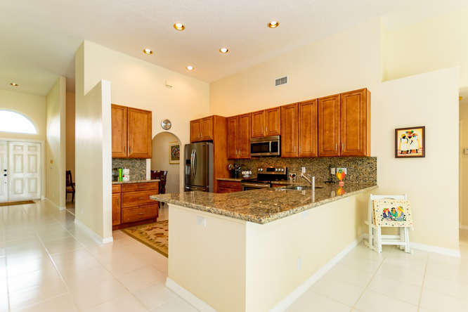 19627 Dinner Key Drive Boca Raton, FL 33498 - Photo 12 of 46 a kitchen with stainless steel appliances granite countertop a sink a stove and a refrigerator