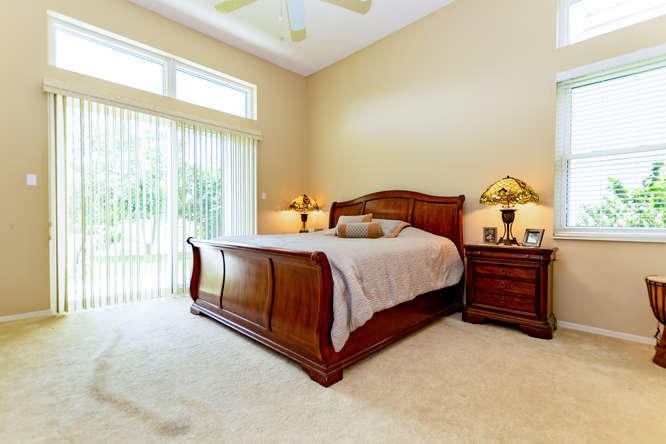 19627 Dinner Key Drive Boca Raton, FL 33498 - Photo 15 of 46 a large bed sitting in a room next to a window