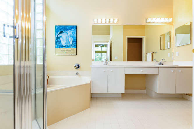 19627 Dinner Key Drive Boca Raton, FL 33498 - Photo 17 of 46 a spacious bathroom with a tub sink and mirror