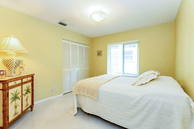 19627 Dinner Key Drive Boca Raton, FL 33498 - Photo 19 of 46 a bedroom with a bed and a window