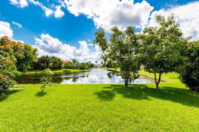 19627 Dinner Key Drive Boca Raton, FL 33498 - Photo 2 of 46 a view of lake with green space