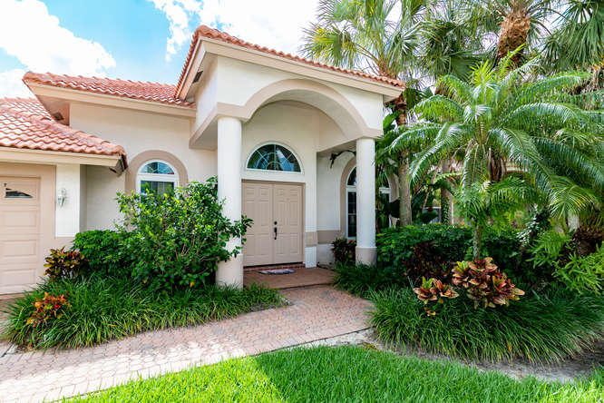 19627 Dinner Key Drive Boca Raton, FL 33498 - Photo 31 of 46 a front view of a house with garden