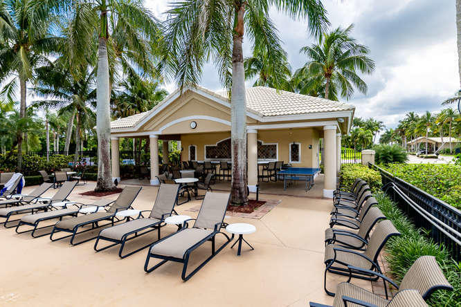 19627 Dinner Key Drive Boca Raton, FL 33498 - Photo 42 of 46 a view of a patio with chairs and potted plants