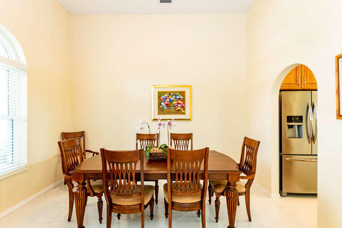 19627 Dinner Key Drive Boca Raton, FL 33498 - Photo 8 of 46 a view of a dining room with furniture and wooden floor