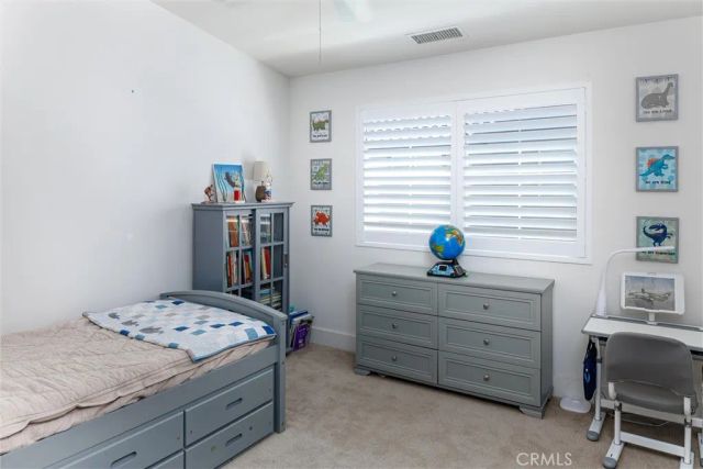 a bedroom with a bed and a table in it