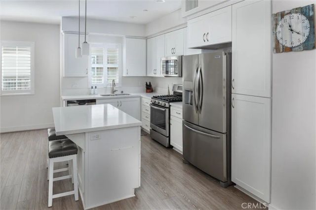 a kitchen with stainless steel appliances a refrigerator stove and sink