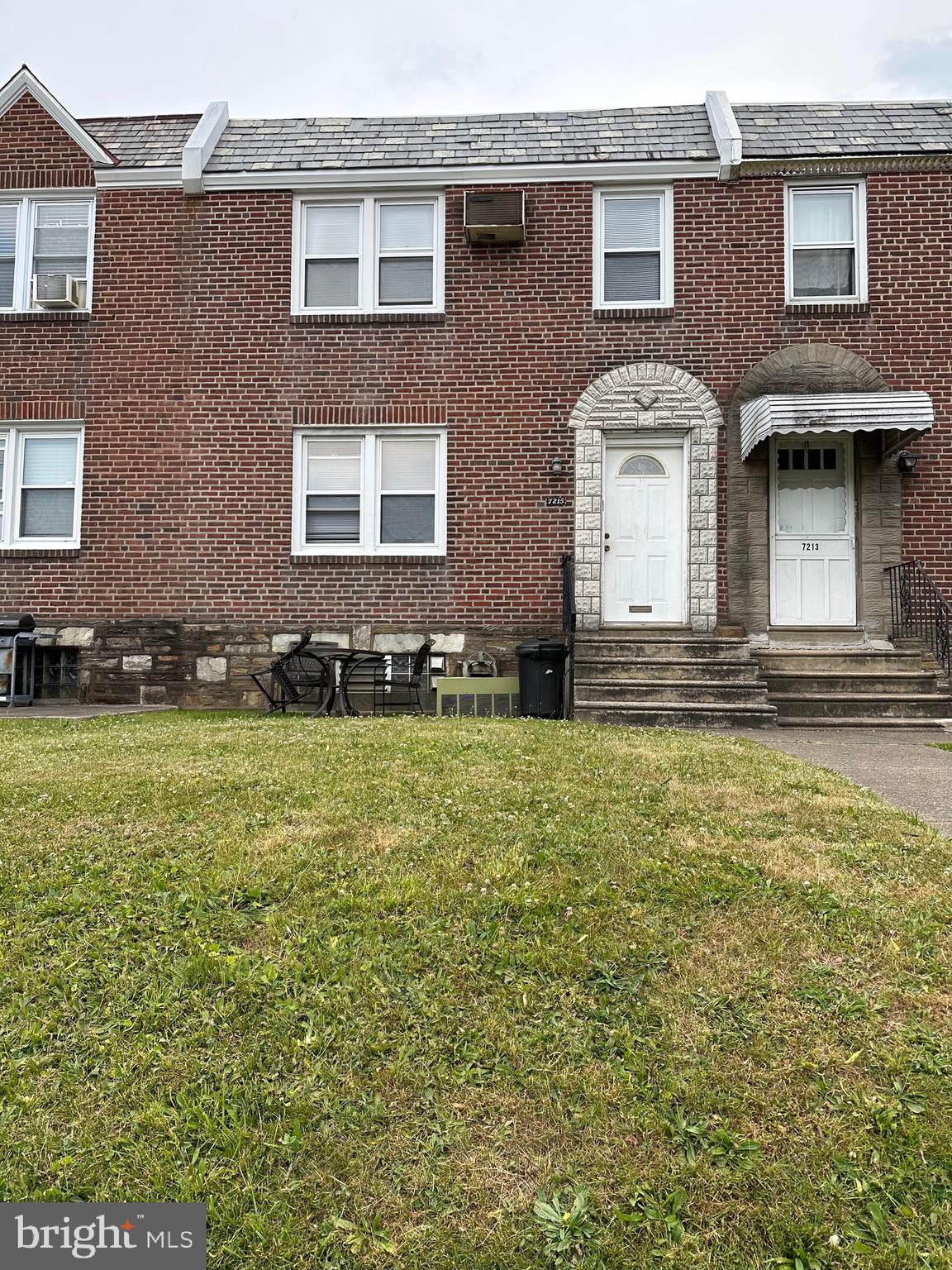 7215 Erdrick Street Philadelphia, PA 19135 - Photo 2 of 12 a front view of a house with a yard
