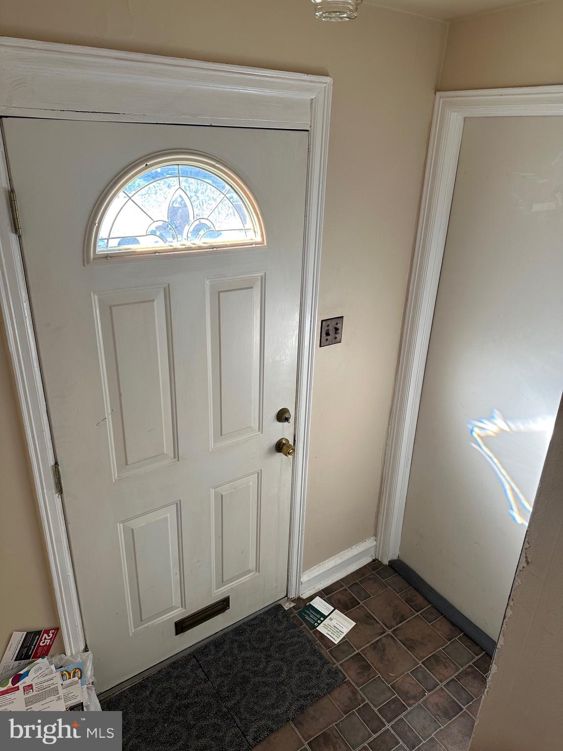 7215 Erdrick Street Philadelphia, PA 19135 - Photo 3 of 12 an empty room with wooden floor and a hallway