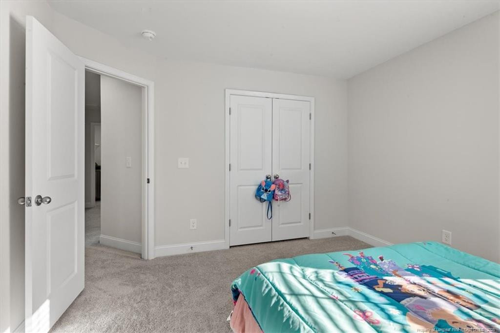 7840 Rufus Johnson Road Fayetteville, NC 28306 - Photo 40 of 50 a bedroom with a bed and a painting on the wall