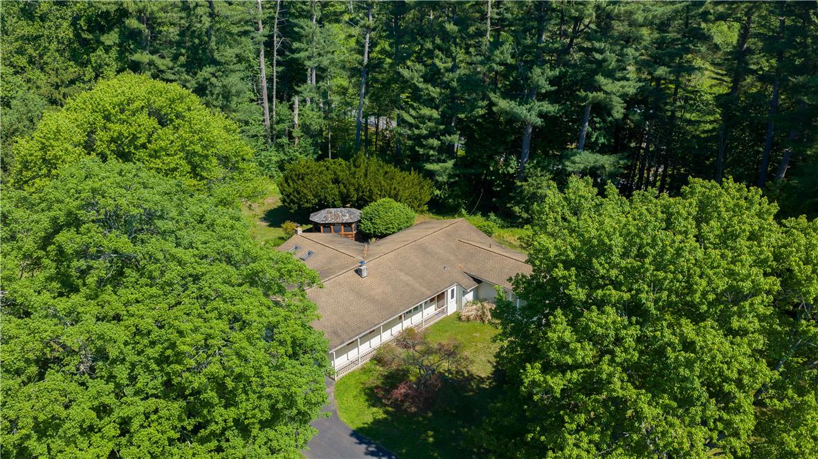 Coldsprings Rd Union Pottstown, PA 19465 - Photo 4 of 71 An aerial perspective reveals a private residence nestled among a dense, verdant tree line with a paved driveway.
